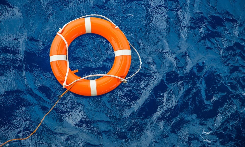 Universal Life Insurance - Safety Equipment, Life Buoy or Rescue Buoy Floating on Sea to Rescue People From Drowning Man.